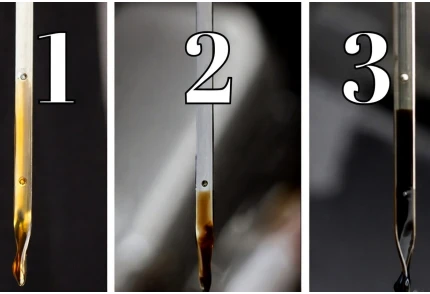 checking oil condition with a dipstick